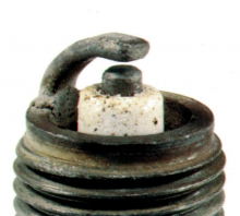 Spark plug with Blistered white insulator and glazed electrodes