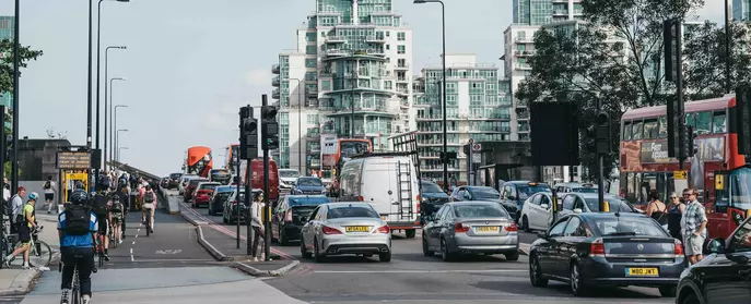 Cars pedestrians cyclists using a road in the UK