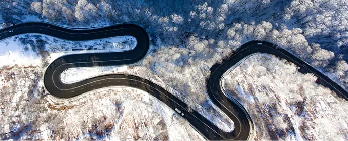 An icy twisty road from above