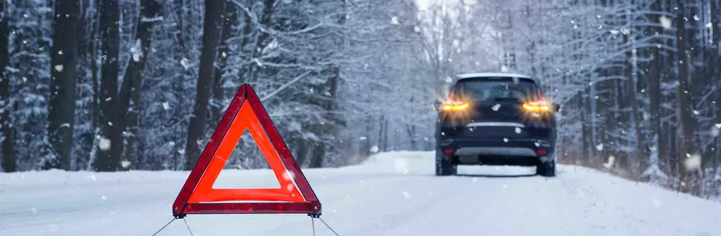 Warning triangle by car in snow