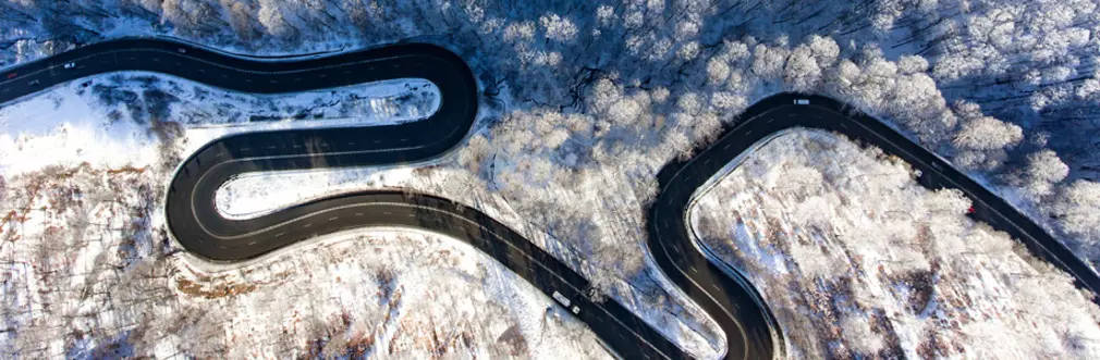 An icy twisty road from above
