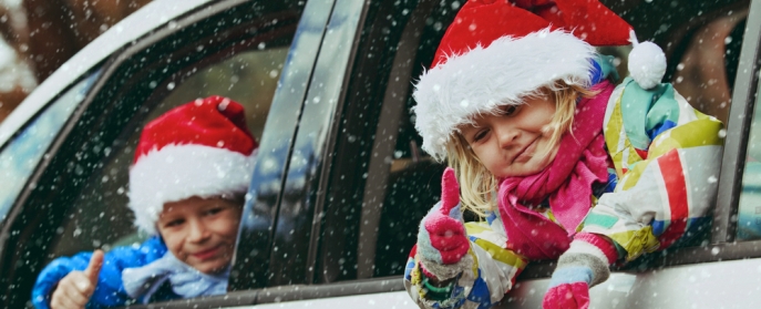Kids in Christmas Hats in snowy car