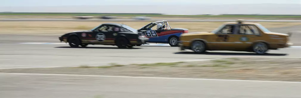 Ford Fairmont, Geo Metro, and Mazda RX7 in 24 Hours of Lemons Race