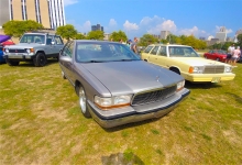 A Buick Roadmaster poses with a Plymouth Reliant K wagon, and a Mitsubishi Montero