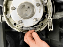 Remove the adjuster lever return spring 
