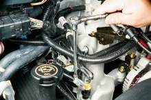 Remove the coil on plug (COP) mounting bolt and lift the assembly from the cylinder head