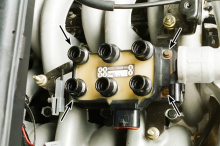 Remove the coil pack mounting screws (arrows) and lift it from the engine