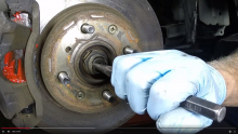 Use a punch or chisel and unstake the drive axle/hub nut