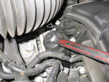 Using a box end wrench or socket, turn the filter cap counterclockwise to remove it (3.6L V6 engine)