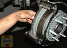 Install the inner brake pad into the caliper mounting bracket