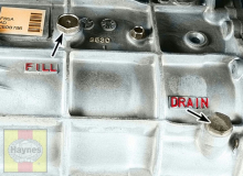 The manual transmission fill plug and drain plug are located on the side of the transmission case