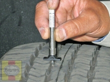 Use a tire tread depth indicator to monitor tire wear