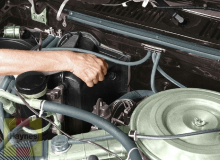The automatic transmission fluid dipstick is near the firewall, to the left of the engine