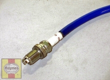 The hose will allow you to turn the plug, but not cross thread it