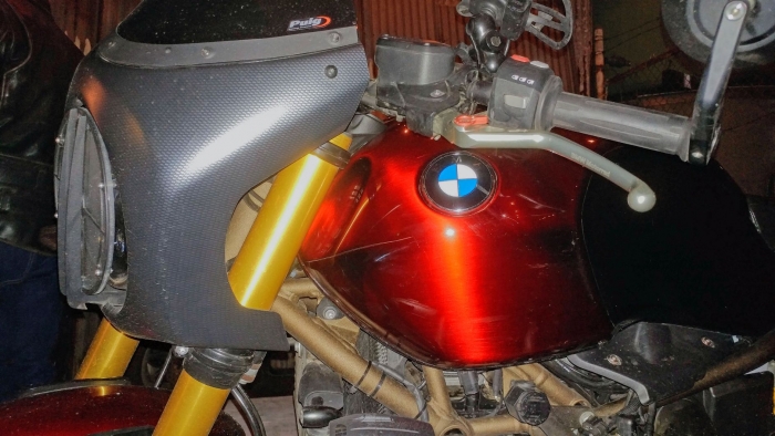 This custom cafe racer contrasts carbon fiber, matte gold on the frame, and a deep candy apple paint job on the tank