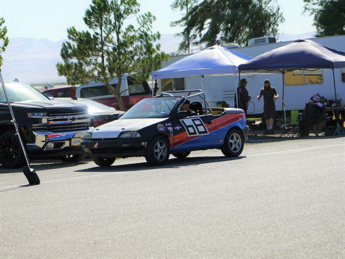 Geo Metro sitting in the pits with its new rad racing paint