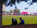 Period dressed show goers rest in the shade